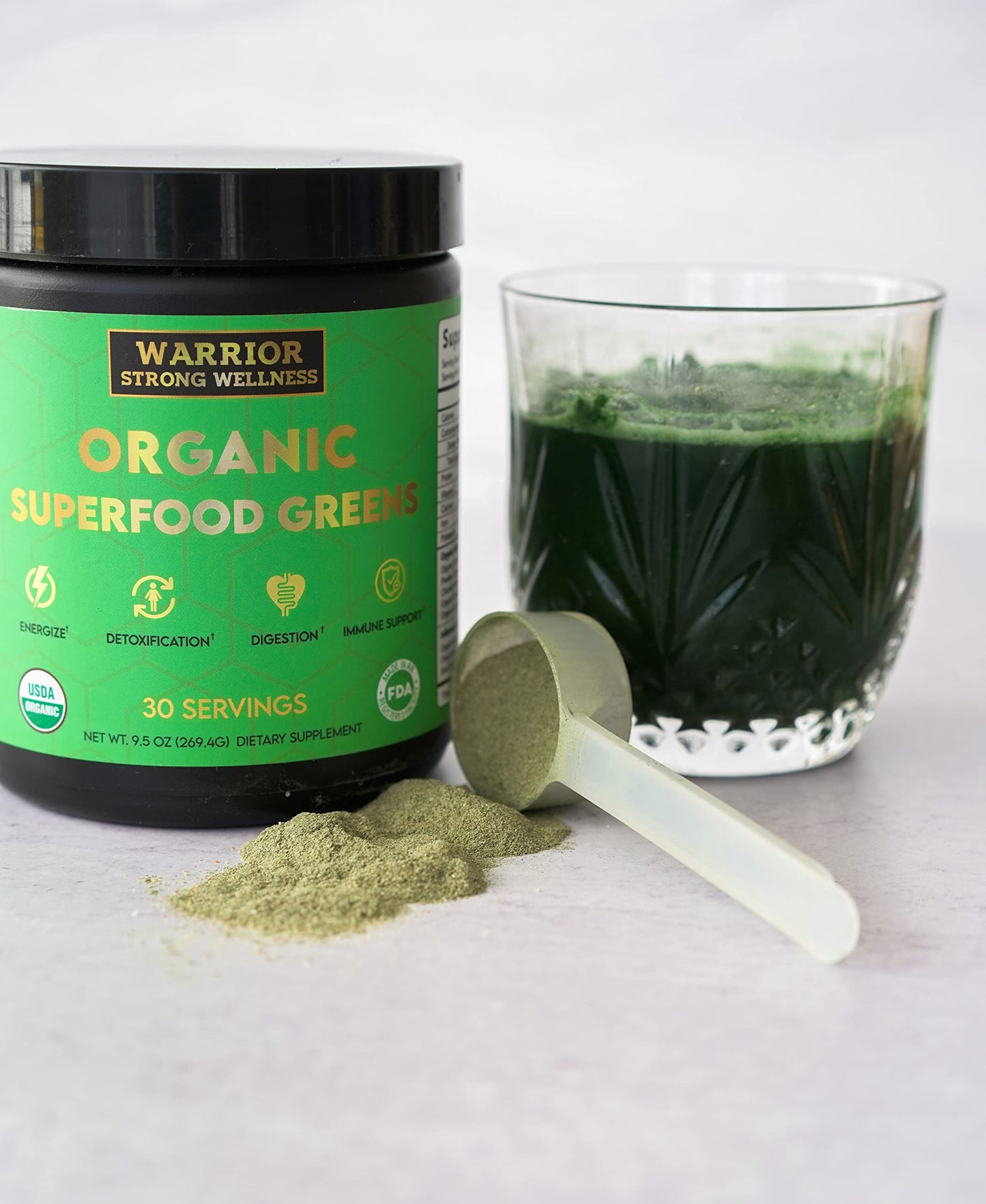 Warrior Strong Wellness Organic Superfood Greens with a scoop of greens powder and a mixed green drink for energy, digestion, detoxification, and immune support.
