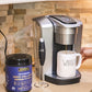 Warrior Strong Wellness Multi Collagen Protein Powder next to a fresh cup of coffee, showcasing an easy daily collagen routine to support skin, joints, muscles, hair, and nails.